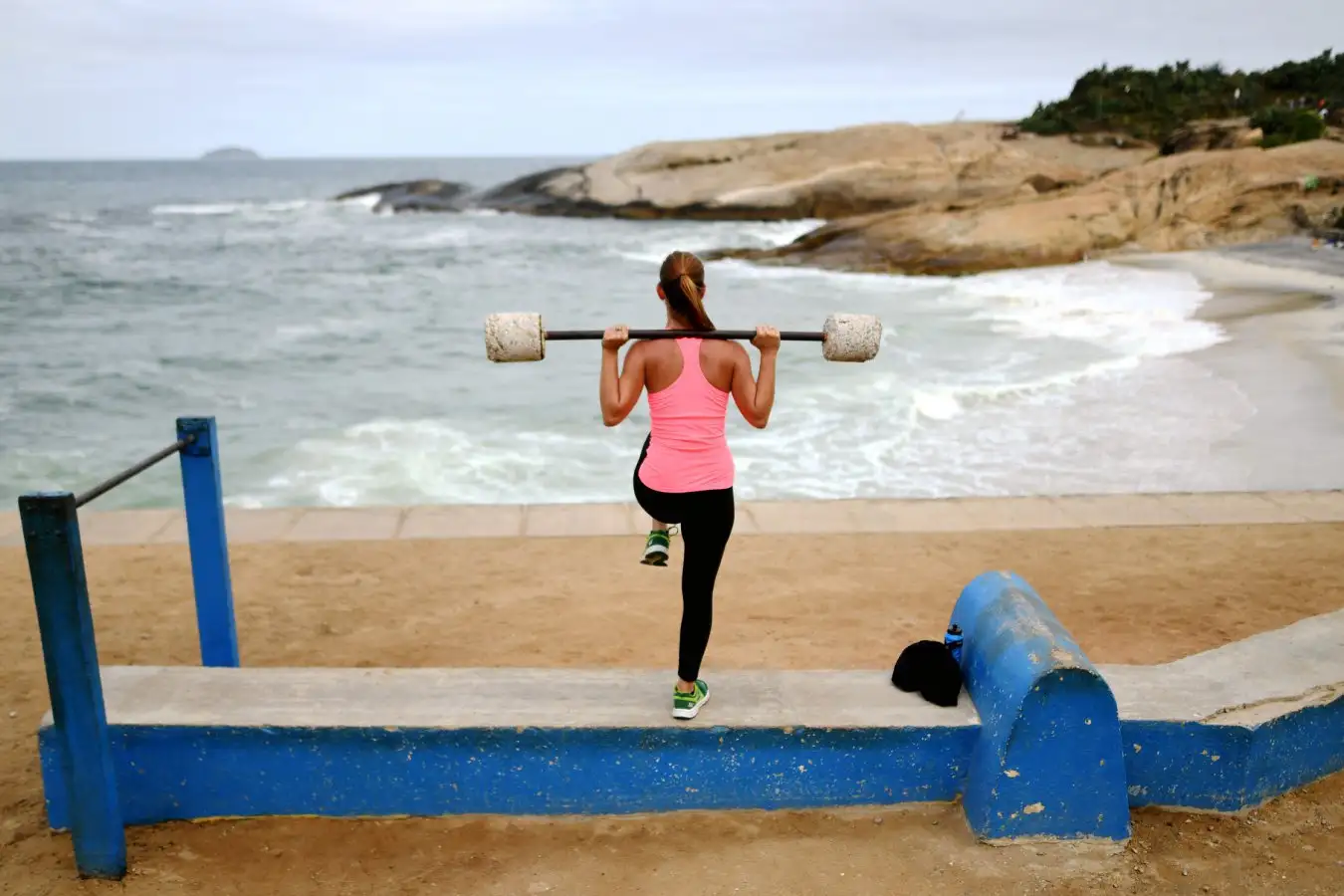 Woman doing a virtual strength workout outdoors